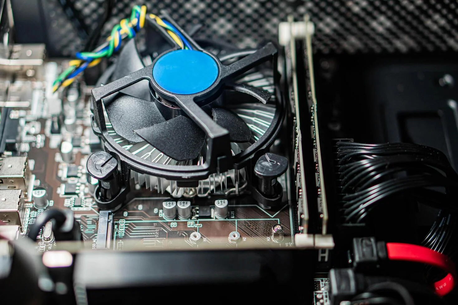 Technician repairing laptop cooling fan and thermal system