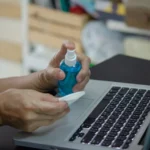 Technician performing laptop dust cleaning to improve performance and prevent overheating