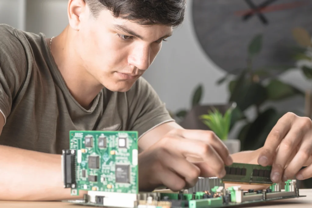 Certified technicians performing laptop motherboard repair