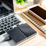 Laptop power supply issues showing technician checking power adapter and laptop charging port