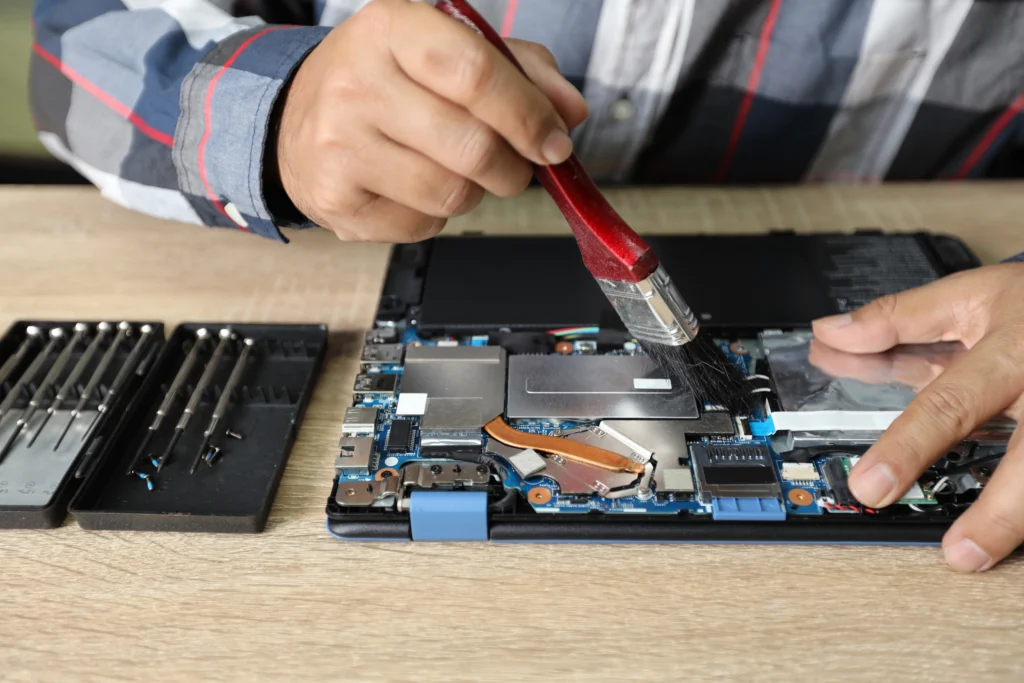 Essential laptop repair tools including screwdrivers, spudgers, and diagnostic kits