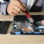 Essential laptop repair tools including screwdrivers, spudgers, and diagnostic kits