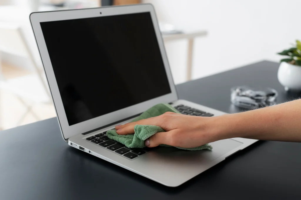 Liquid-damaged laptop keyboard being repaired by a technician