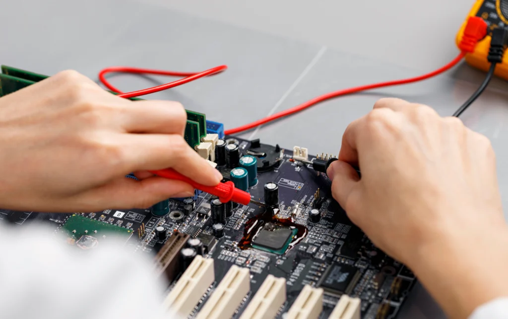 Power jack charge port repair on a laptop motherboard by a technician